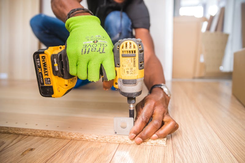 Person using a cordless power drill for home repair work